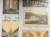 several old postcards of women in dresses are displayed on a table