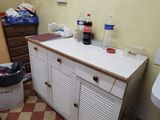 a sink and a cabinet in a room with a checkered floor
