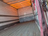 a truck that is parked in the street with its door open