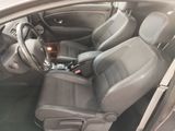 the interior of a car with a bottle of wine in the passenger seat