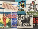 a lot of old movie posters on display on the wall