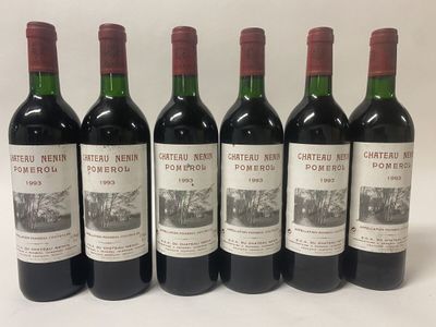 six bottles of red wine are lined up on a white surface