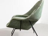 an image of a green chair sitting on top of a white floor