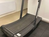 a treadmill in the corner of a room with a heater on the wall
