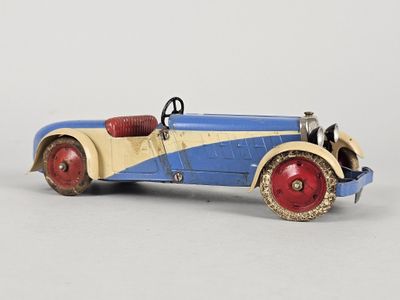 an old fashioned toy car with red wheels and a blue body