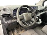 the interior of a car with a steering wheel and dashboard controls