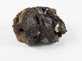 a close up of a piece of black rock on a white surface
