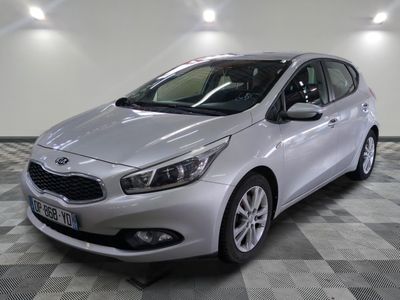 the silver car is parked on a checkered floor in the garage