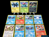 Plusieurs cartes Pokémon sont disposées en rangée sur un fond noir