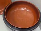 two brown bowls sitting on top of a white counter