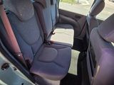 the back seats of a car that is parked on the side of the road