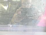 a man taking a picture of himself through the window of a car