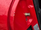 a close up of a red car with its door open