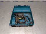 a blue box with a drill and a cord in it