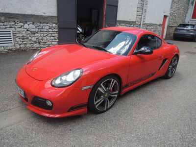 a picture of a red sports car parked in front of a building