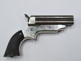 a close up of a revolver on a white surface