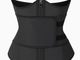 a woman wearing a black corset with zippers on it