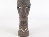 an image of a wooden sculpture of a face on a white background