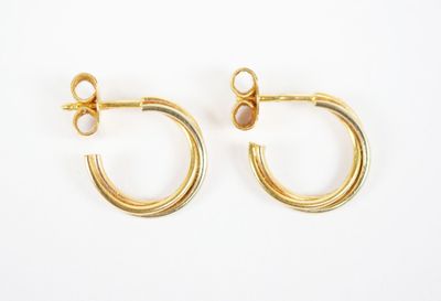 a pair of gold hoop earrings on a white background