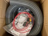 the inside of a cardboard box with a hose and wires in it