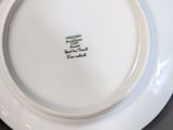 a white plate with green writing on it on a table