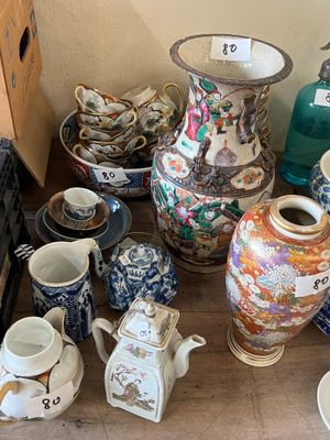 many different vases and bowls on the floor