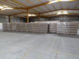 a large warehouse with pallets of wood in it