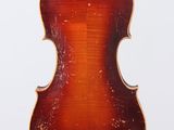 an old violin hanging from a string on a white background