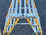 a yellow and silver step ladder sitting on the ground