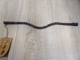 a snake that is laying on the floor next to a stick