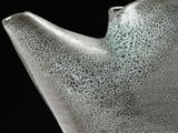 a close up of a glass vase with a black background