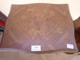 a wooden table with a flower design on it