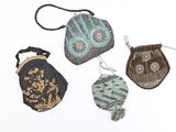 three small purses are sitting next to each other on a white surface