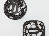 two black iron tsubai with a dragon and a fish design