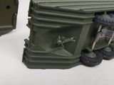 a toy army vehicle with a large box on the back