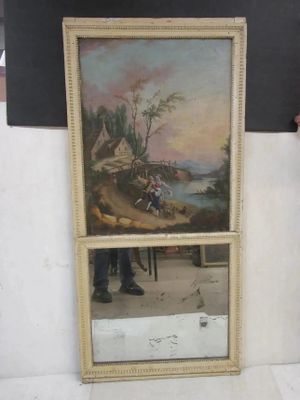 a man standing next to a painting on the wall