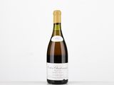 a bottle of wine sitting on top of a white table