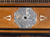 a wooden table with a decorative design on it