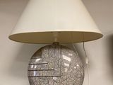 a lamp that is sitting on a shelf next to a television