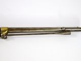 an old gun with a wooden handle on a white surface