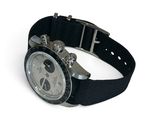 a watch that is sitting on a black strap