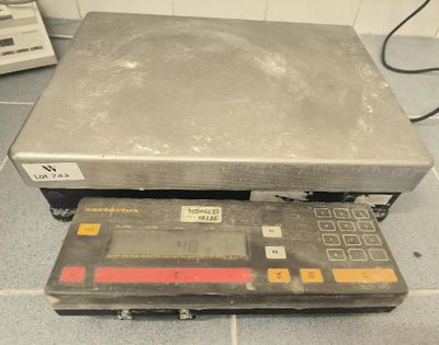 an image of a scale on the floor of a kitchen