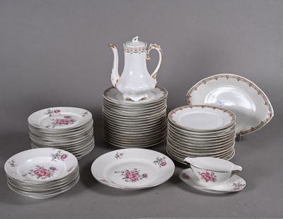 many plates and cups and a pitcher on the table