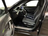 the interior of a car with the door open and the driver ' s seat up