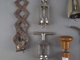 many different types of wine openers on the wall