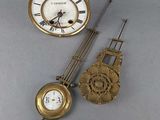 two clocks that are sitting next to each other on a table