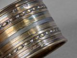 an image of a close up of a metal bracelet on a table
