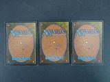 three magic the gathering booster cards