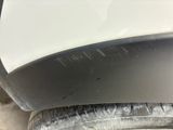 a close up of a car ' s front bumper and tire