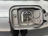 a close up of a car ' s fuel tank with a plug attached to it